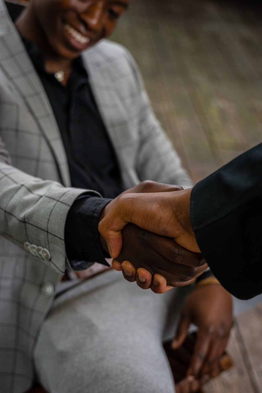 Two business partners shaking hands to close an acquisition