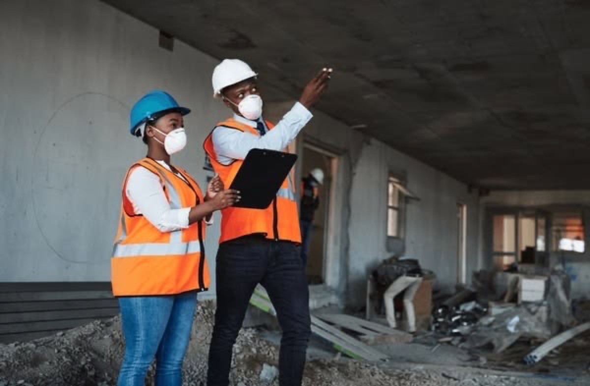 Two engineers reviewing findings on site during a verification visit