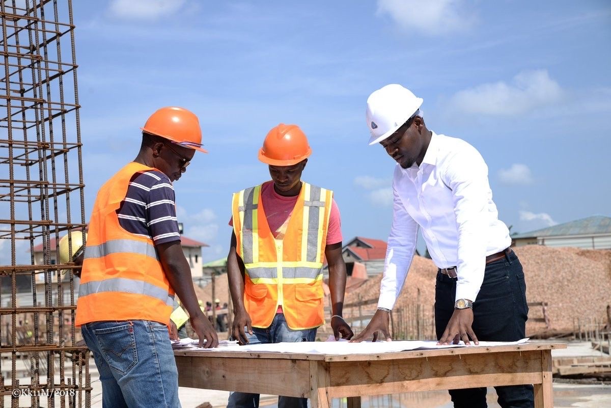 Engineers reviewing infrastructure plans on site